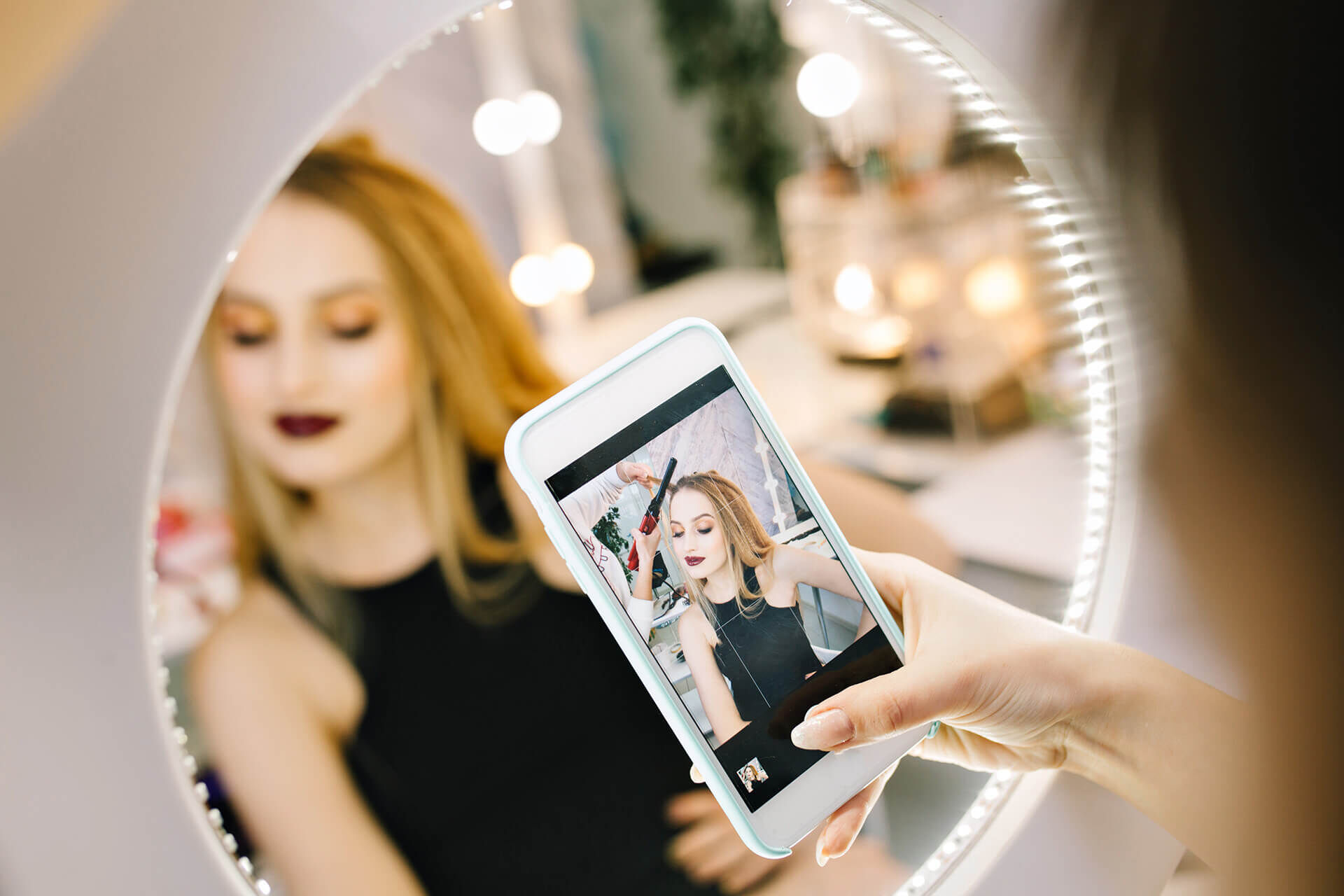 elegant-pretty-young-woman-making-photo-phone-mirror-during-making-hairstyle-hairdresser-salon-stylish-fashionable-model-preparing-party-celebration-luxury-look