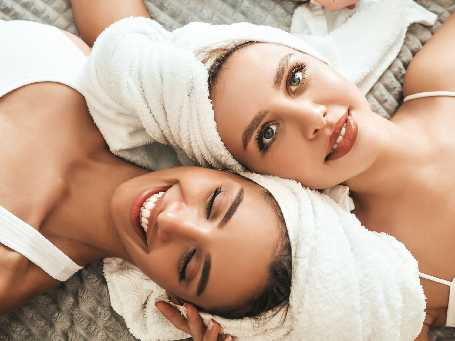 two-young-beautiful-smiling-women-white-bathrobes-towels-head
