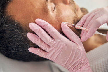 close-up-unshaven-young-man-receiving-injectable-skincare-treatment-wellness-center