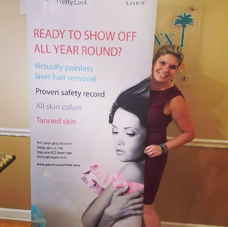 tampa beauty treatment for hair removal Tami standing behind banner at tampa beauty event