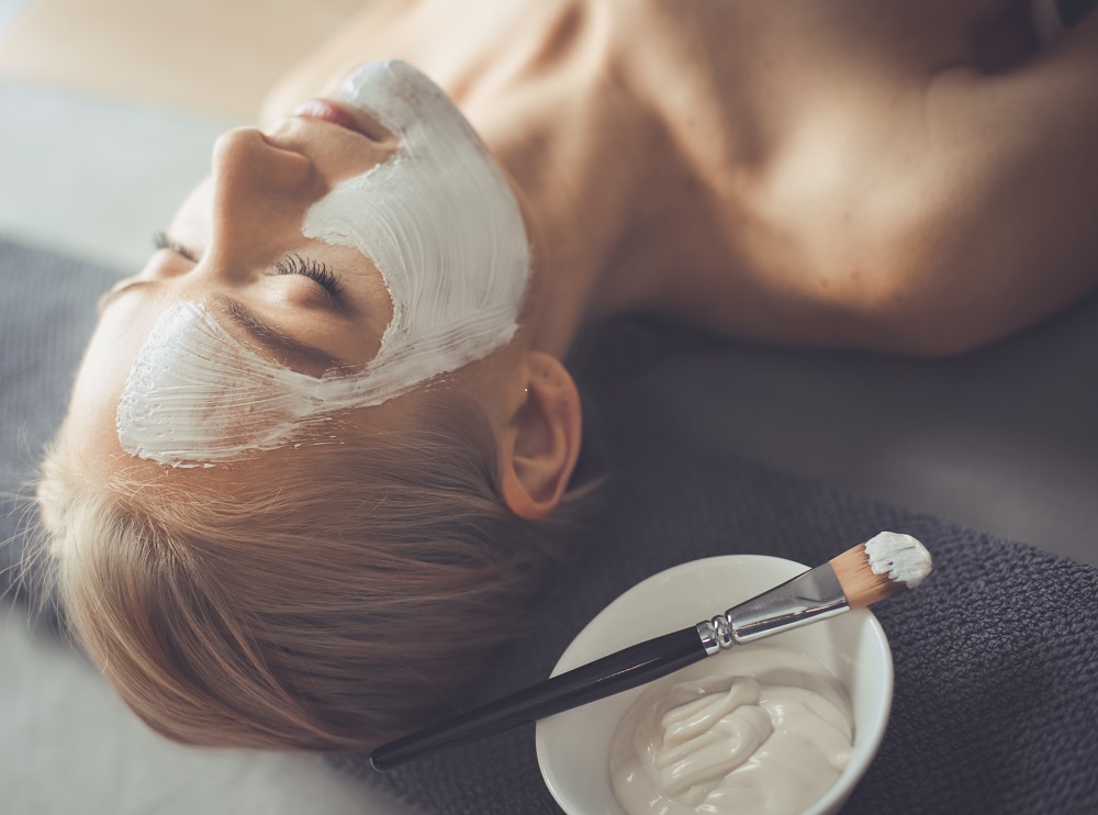 women getting a facial laying down
