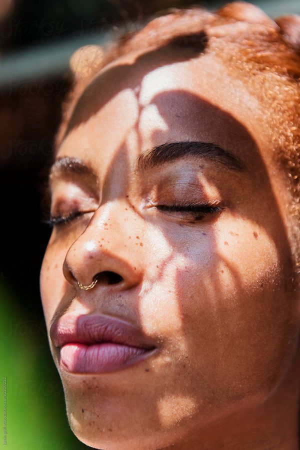 women closing her eyes with the sun on her face